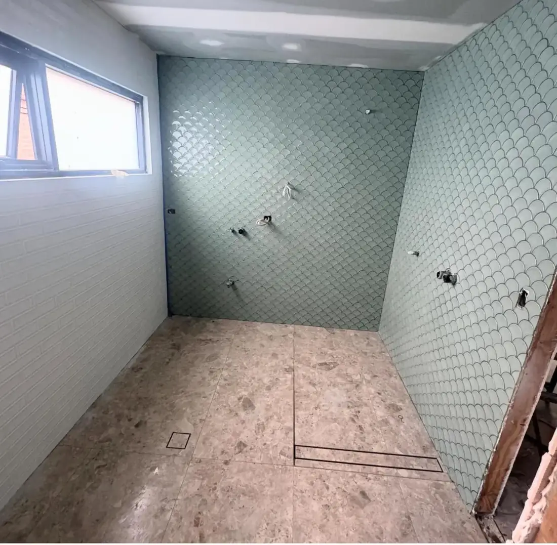 Fish-scale tile feature wall mid-renovation