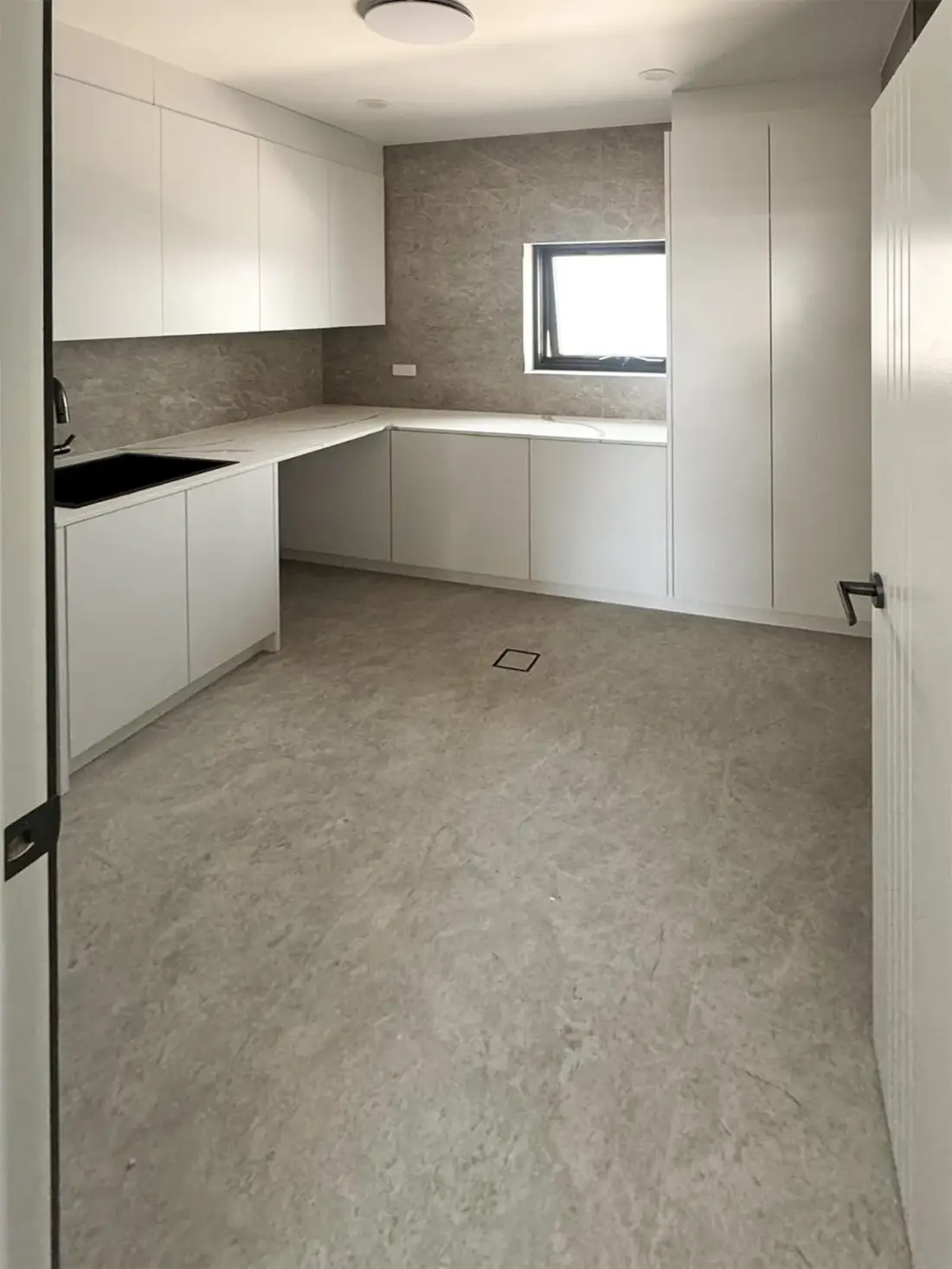Modern butler's pantry with stone benchtop and integrated cabinetry